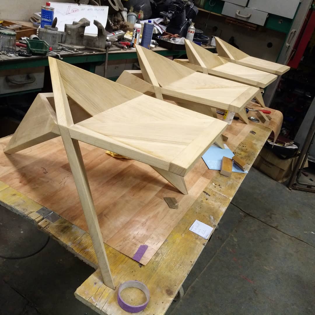 Four finished Alone in Kyoto stools in a workshop